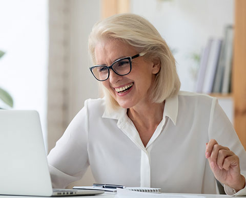 Smiling Woman Checks LASIK Cost in Reno