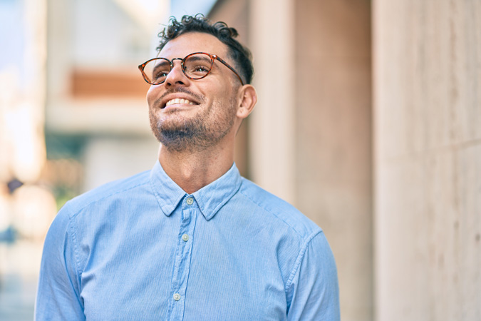 man with eyeglasses happy looking at the sky in LASIK of Nevada